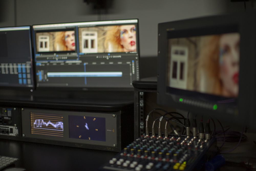 A grading session in the edit suite, with a close-up portrait on the client monitor