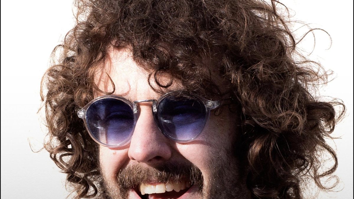 Josh Pugh laughing in blue-tinted sunglasses
